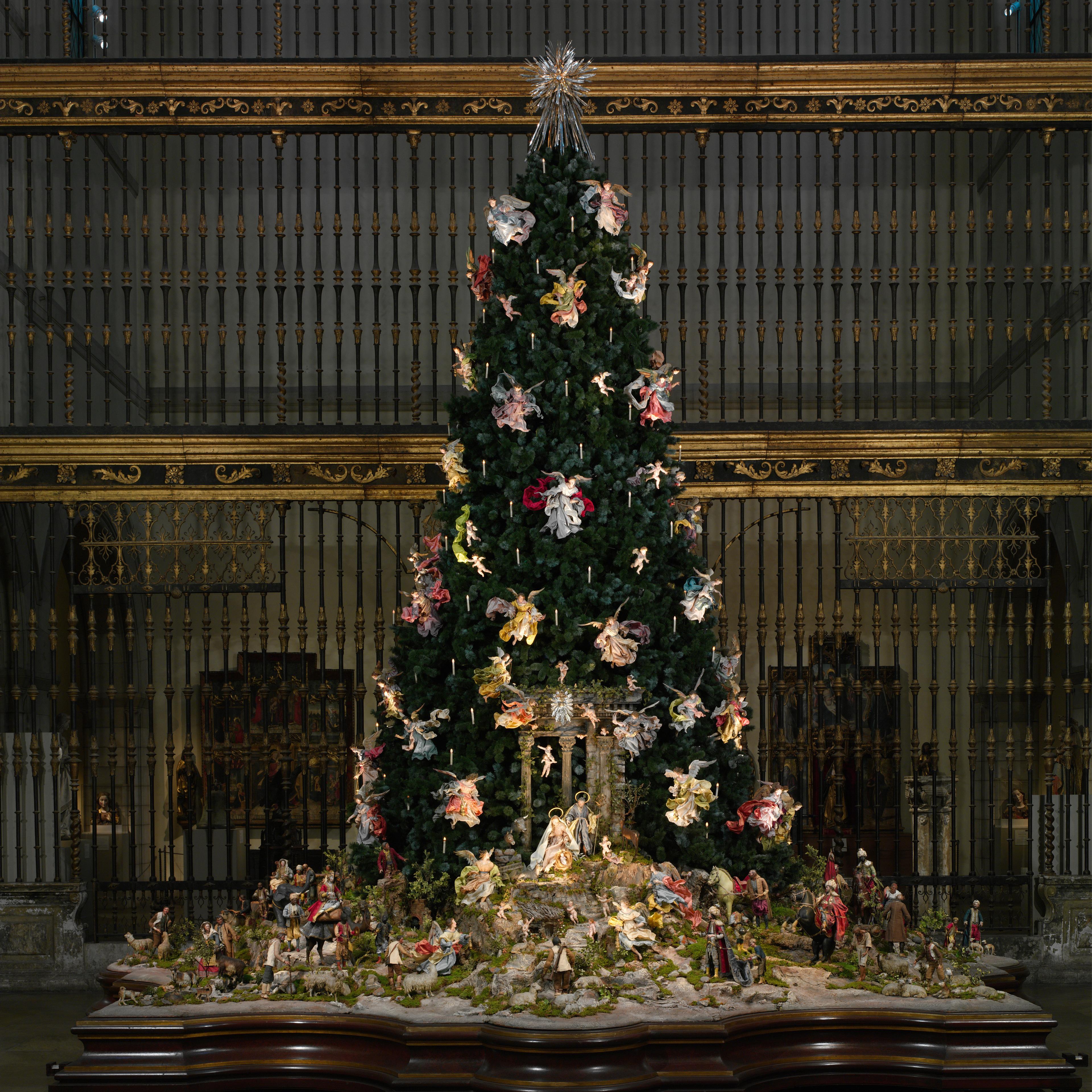 Christmas Tree standing tall with holiday ornaments. 