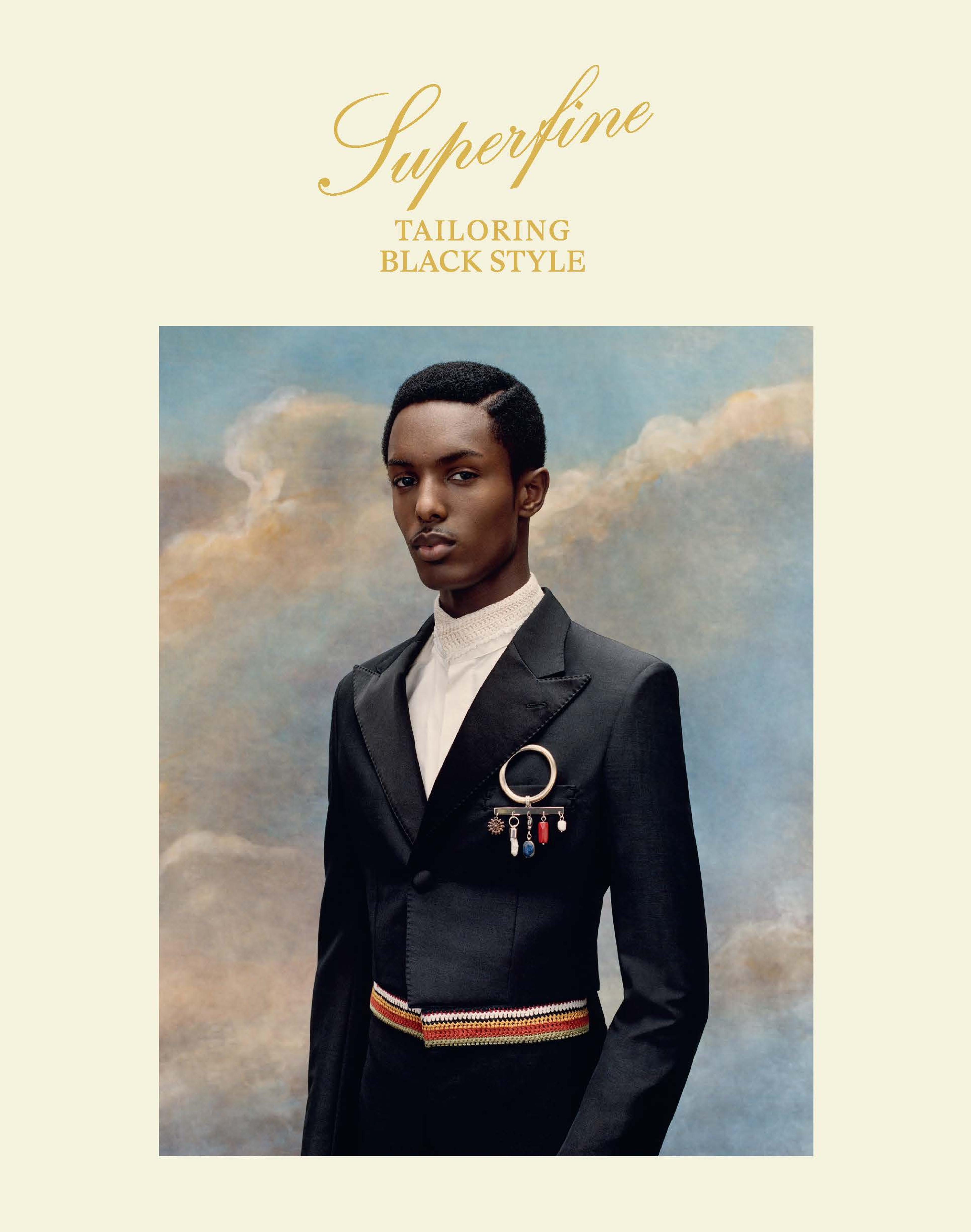 a young black man in a Wales Bonner suit standing against a background of a blue sky and clouds