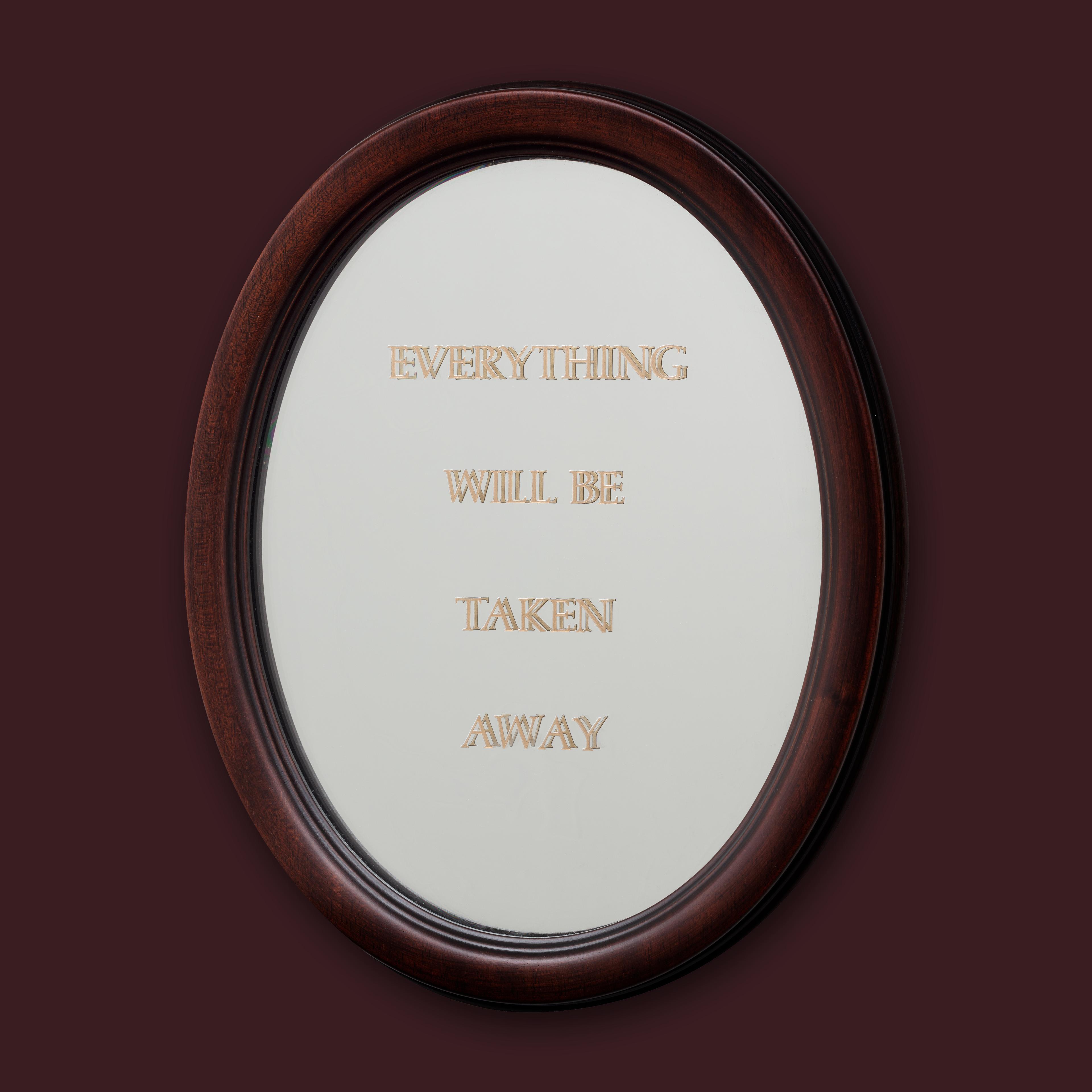 Brown backdrop with an oval mirror in the center that reads " Everything Will Be Taken Away" in capital letters.