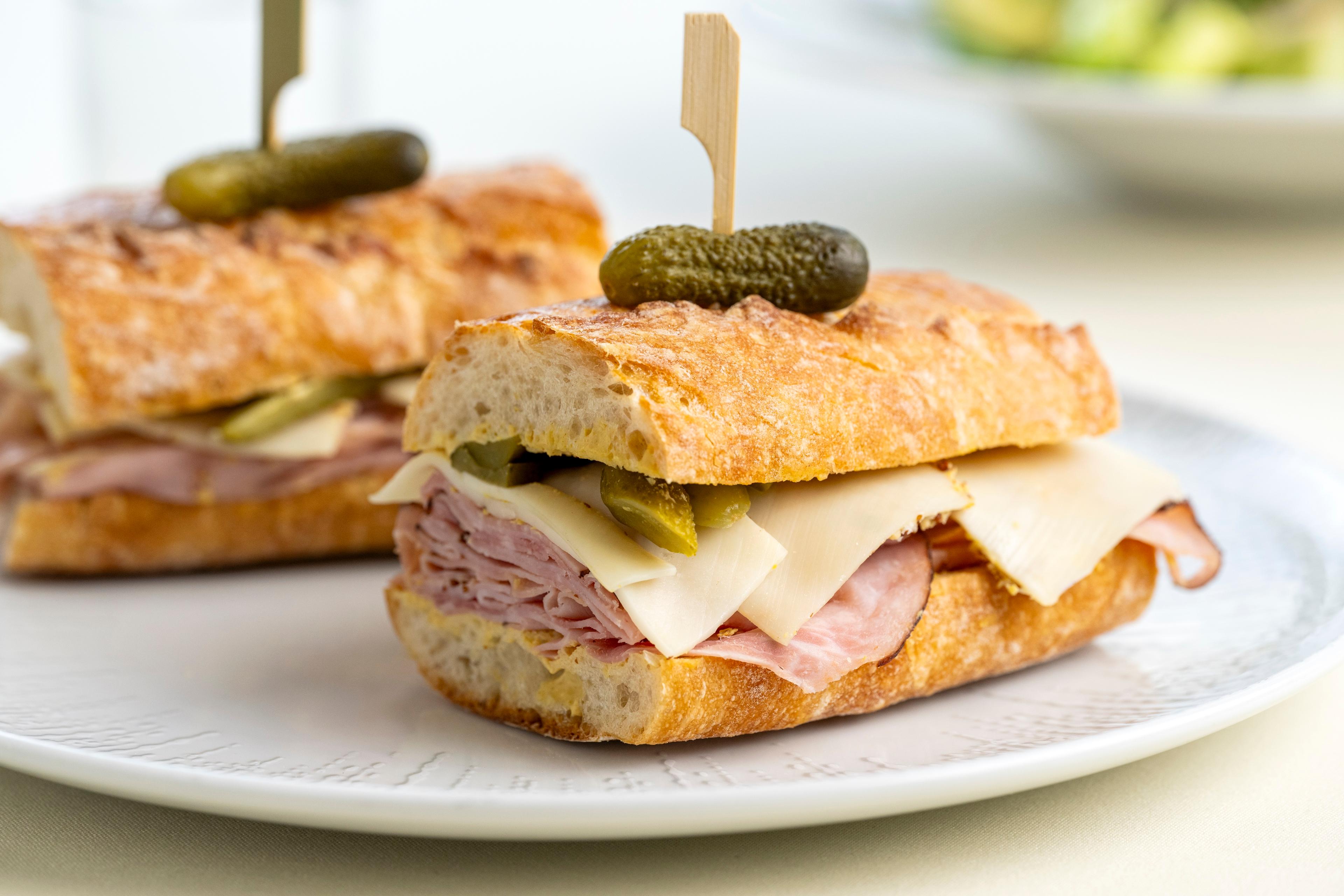 A ham and cheese sandwich on a platter.