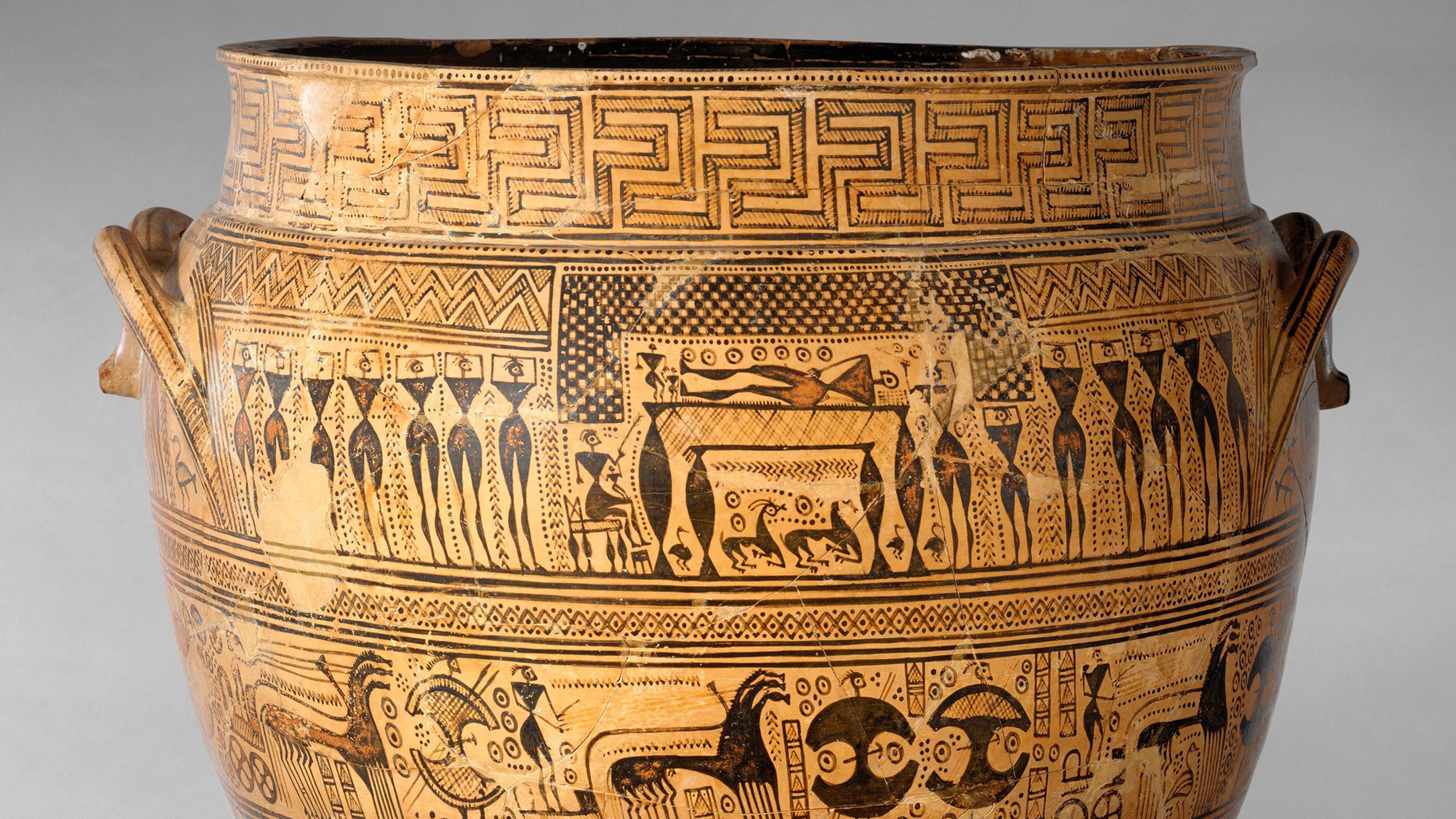 Marble statue of three women standing and leaning toward each other. Sections of the statue are missing including arms and all the heads of the women.