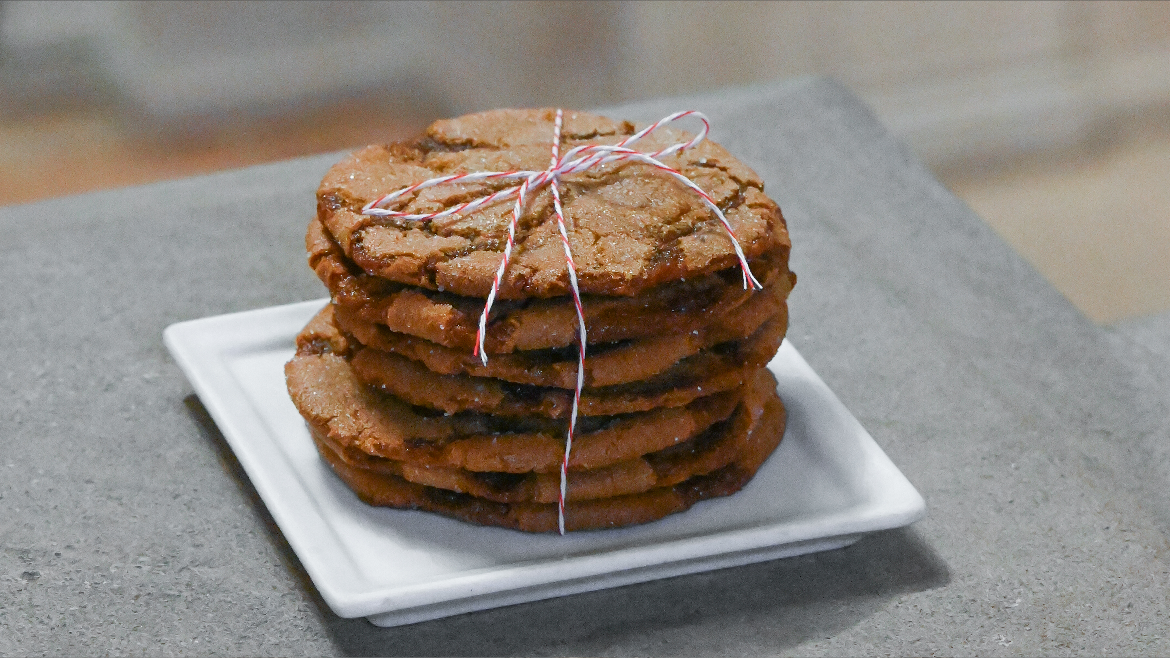 A stack of holiday cookies wrapped in ribbon. 